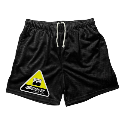 a black shorts with a yellow triangle on the side