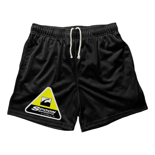 a black shorts with a yellow triangle on the side